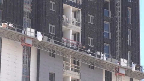 Workers glueing bricks outside of tower Video stock 106770378