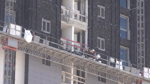 Workers glueing bricks outside of tower Stock Footage 106770906