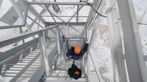 Workers go up on building ground against construction site Stock Footage 94759654