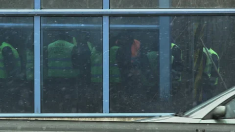 Workers in Green Jackets. Dirty Large Orange Truck Appears Stock Footage 87868132