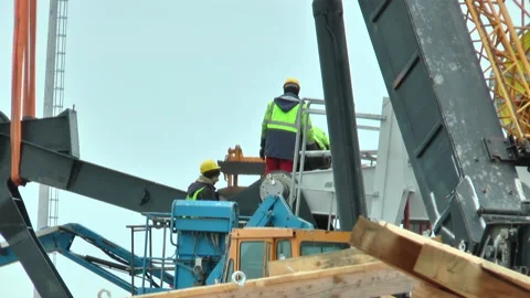 Workers in green vests work at height Video stock 232215702