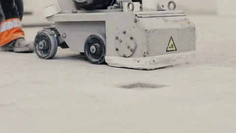 Workers grind the concrete floor at the construction site. Prepares the floor Stock Footage 152340762