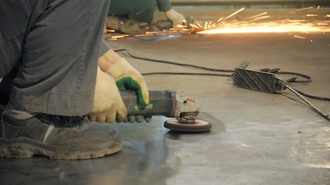 Workers with grinder protects the metal surface. Workers in the workshop of the Stock Footage 125491169
