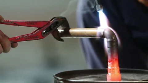 Workers grinding and welding copper pipes in a industrial factory Stock Footage 72962718