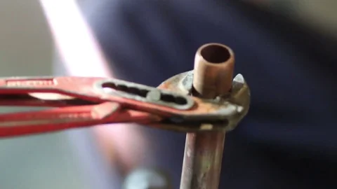 Workers grinding and welding copper pipes in a industrial factory Video stock 72962765