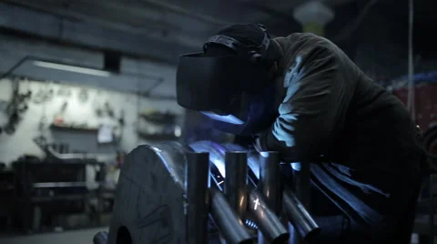 Workers grinding and welding in a factory. Stock Footage 60468778