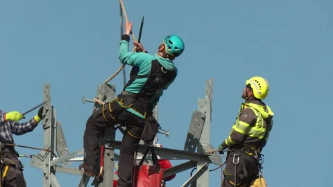 Workers Guiding Pylon During Helicopter Installation Stock Footage 341968057