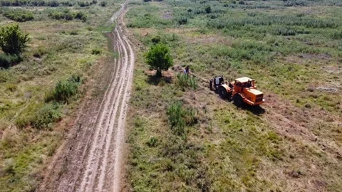 Workers guiding rope to ensure proper placement under ground for power Stock Footage 300853001