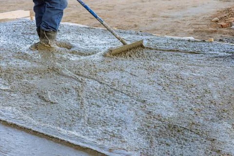 The workers had to work quickly during the pouring of the concrete to avoid any Stock Photos