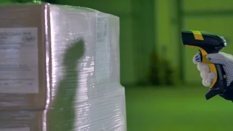 Workers hand with Bar Code Scanner scanning goods at a warehouse. 4K. Video stock 80832411