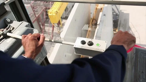 Workers hand contols the crane. Camera closeup inside the cabin. Stock Footage 70208002