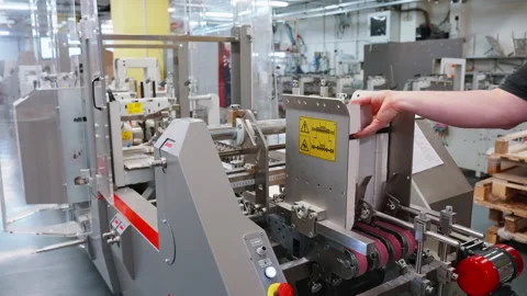 Worker's hand controls the printing process. Paper submission. Printing house Stock Footage 238549589
