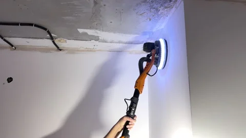 Worker's hand with eccentric long handle grinding machine Stock-Footage 168515766