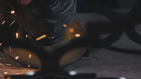The worker's hand holds an angle grinder with a circular cutting blade Stock Footage 74691362