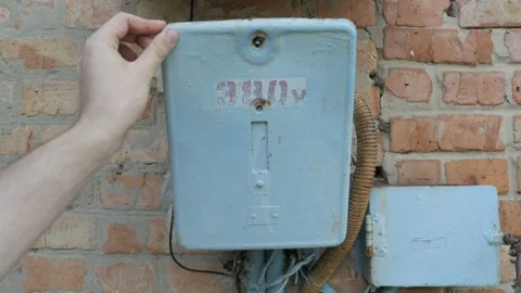 Worker's hand opens and closes a control panel of the old broken switchboard Stock Footage 90667046