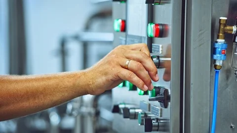 Worker's hand pressing buttons of a mechanical machine at manufacturing plant Stock-Footage 117253650