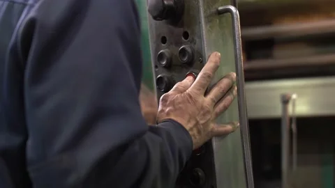 Worker's hand pushing button while working with the industrial machine Stock Footage 149970793