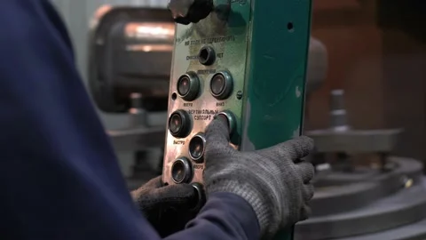 Worker's hand pushing button while working with the industrial machine Stock Footage 149970969