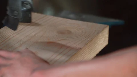 Worker's hand sawing a board with a circular saw. 스톡 동영상 126775436