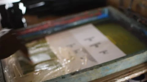 A worker’s hand screen printing on acrylic plastic 動画素材 326930339