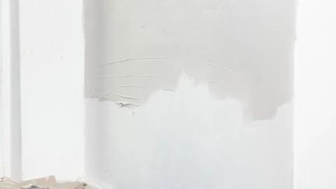 The worker's hand smoothing wall before painting. Stock-Footage 219891699