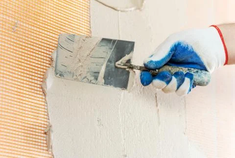 The worker's hand with a trowel. Stock Photos