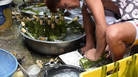Workers hand washing recycled used wine bottles for local home made liquor. Stock-Footage 141316640
