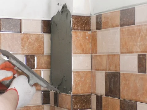 The worker's hands are putting tiles adhesive Stock Footage 79249677