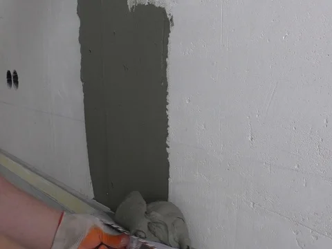 The worker's hands are putting tiles adhesive. Stock Footage 79386891