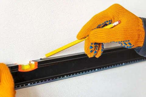 Worker's hands with bubble level.pencil Stock Photos