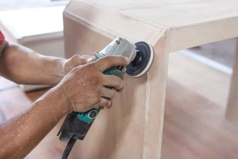 Workers hands at carpenter workspace refining the surface of woo Stock Photos
