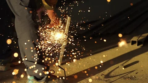 Worker's hands hold a working angle grinder. Video stock 171676632