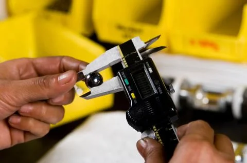 Worker's hands holding calipers Foto stock