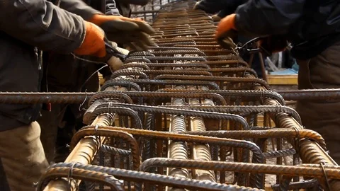 Worker's hands knitting metal rods to each other with wire. Stock Footage 126293428
