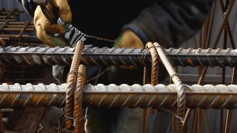 Worker's hands knitting metal rods to each other with wire. Stock Footage 126293441