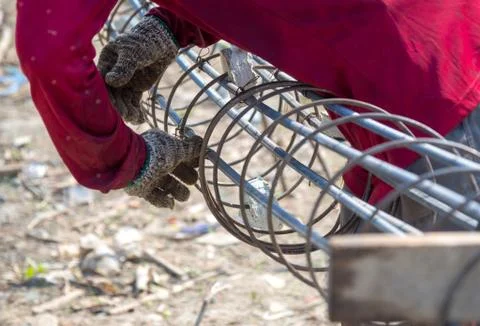 Workers hands put on gloves using hand to iron wire to tie for structure the Foto stock
