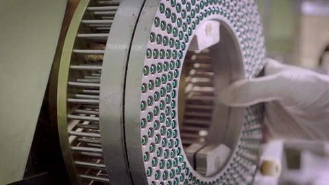Workers hands removing equipment with blue-green hard shelled capsules Stock Footage 102455822