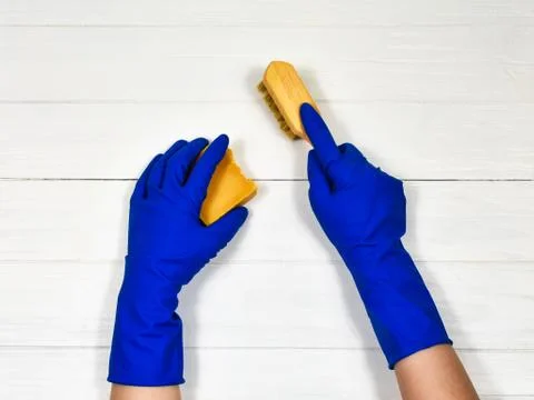 Worker's hands in rubber protective gloves with a rag, wiping the surface of a Stock Photos