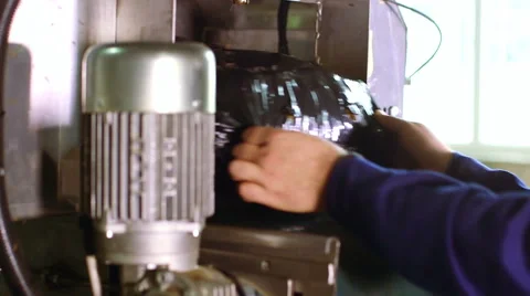 Worker's hands takes packed straw in black bag from producing line in factory Stock-Footage 50305221