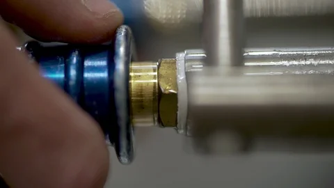 Worker's hands testing gears with high pressure machine 스톡 동영상 111772800