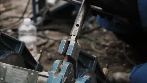 Workers hands tightening a pipe welding machine fastener with a wrench. Stock Footage 318570632