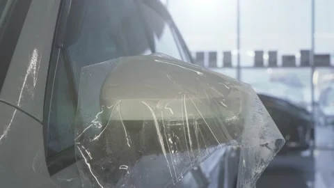 Workers hands wraps wet Paint Protection Film or anti-gravel protection coating Stock Footage 147291228