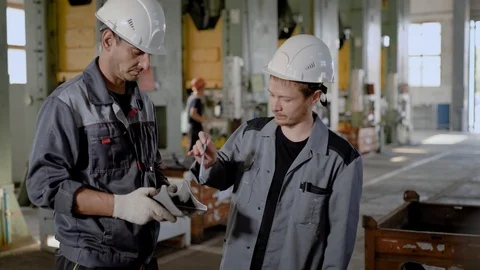 Workers in hardhats standing in workshop Stock Footage 95020805