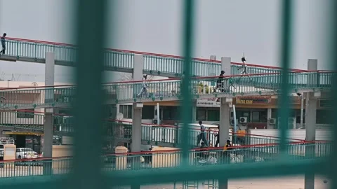 Workers heading to the city on a pedestrian bridge in Dubai, UAE. Stock Footage 341625068
