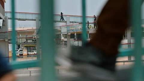 Workers heading to the city on a pedestrian bridge in Dubai, UAE. Stock Footage 341625282