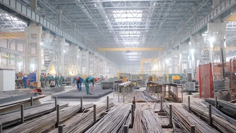 Workers in helmets fasten large metal rebar plate forms Stock Footage 125009112