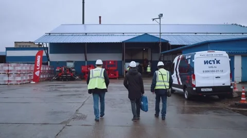 Workers in helmets go to the factory Stock Footage 221277236