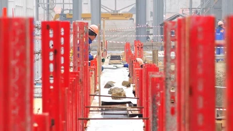 Workers in helmets perform installation work on the foundation Stock Footage 74108896