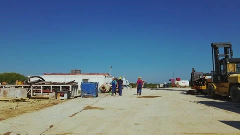 Workers in helmets walking on production site of enterprise. Technical Stock Footage 209277373