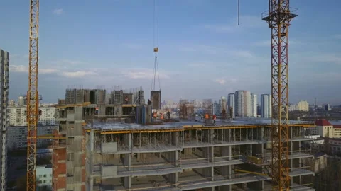 Workers on a high-rise building in the evening clog the formwork for pouring Stock Footage 153601644